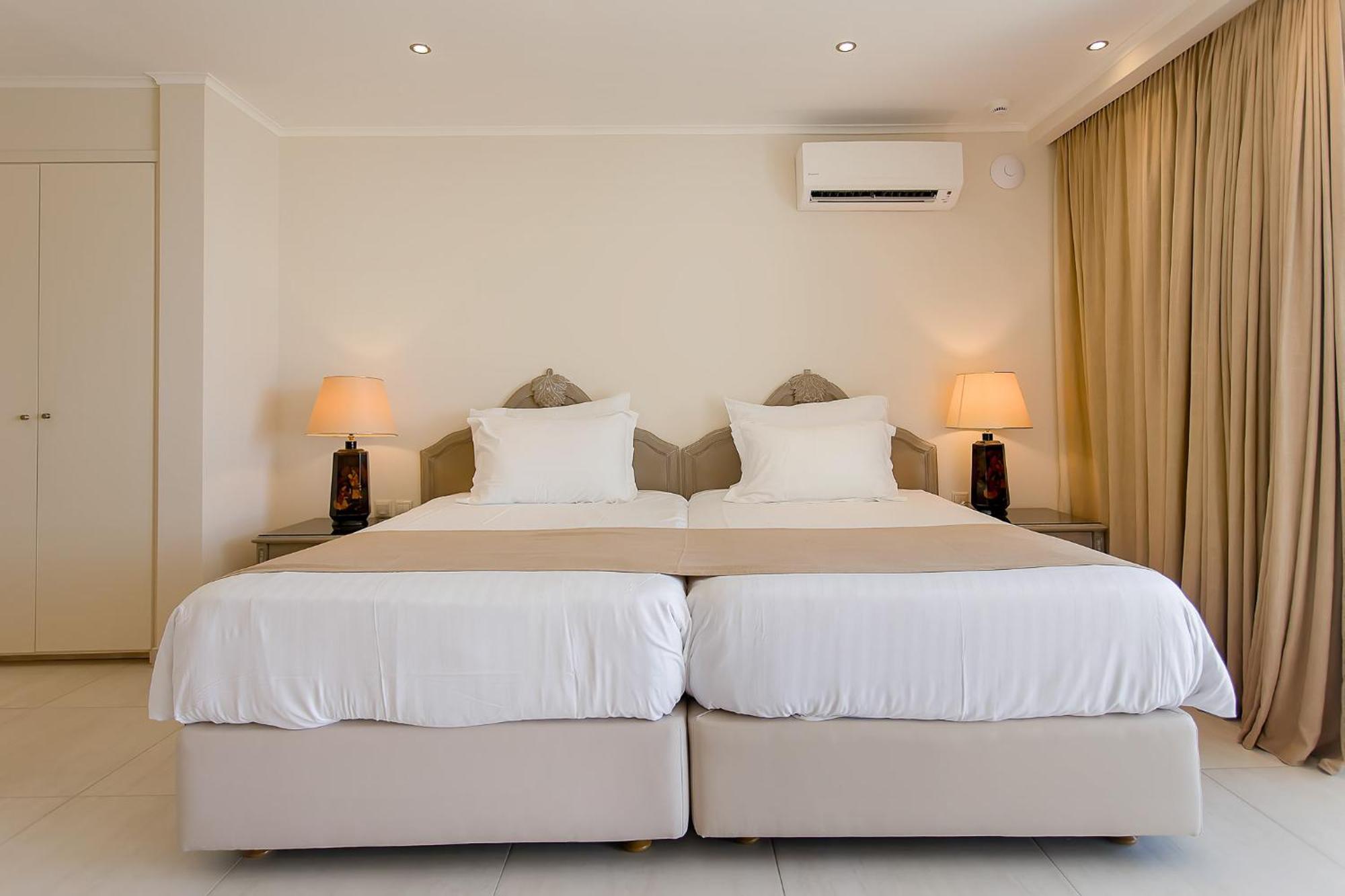 Corfu Holiday Palace Perama  Exterior photo A bedroom with two single beds